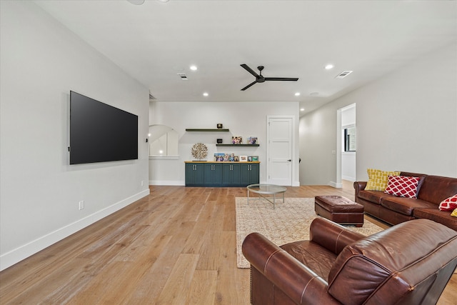 living room featuring ceiling fan and light wood-type flooring