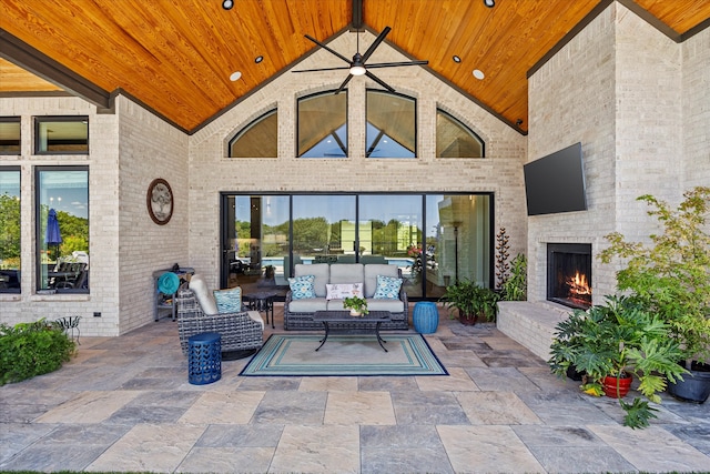 view of patio / terrace with an outdoor living space with a fireplace