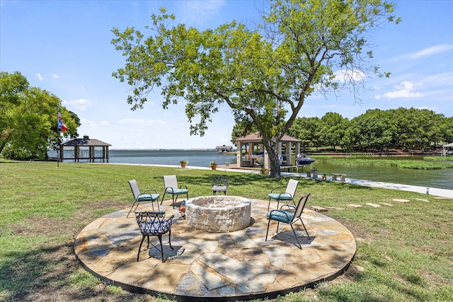 exterior space with a water view, a gazebo, and an outdoor fire pit