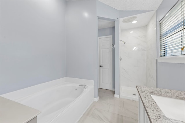 bathroom with tile patterned flooring, vanity, separate shower and tub, and a textured ceiling