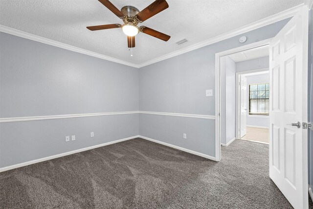 carpeted empty room featuring ceiling fan, a textured ceiling, and ornamental molding