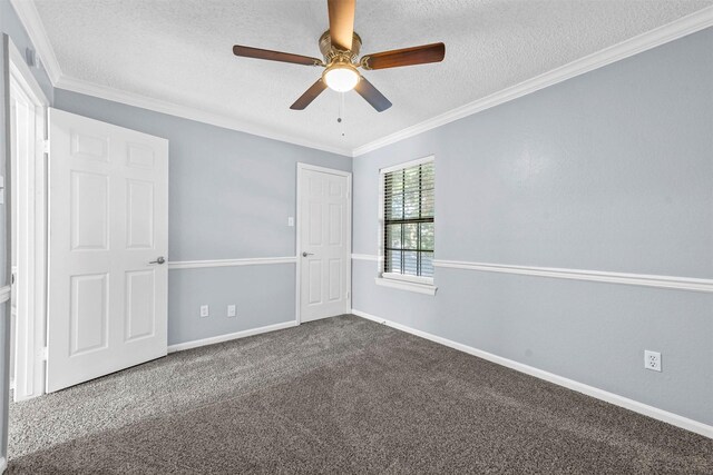 spare room featuring a textured ceiling, carpet, ceiling fan, and ornamental molding