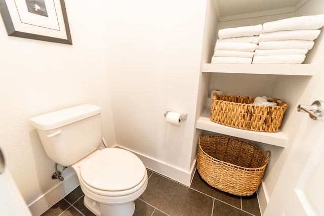 bathroom with toilet and tile patterned floors