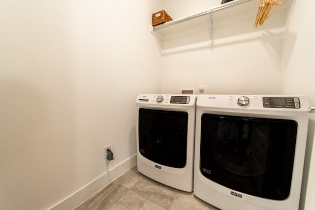 laundry area with washing machine and clothes dryer