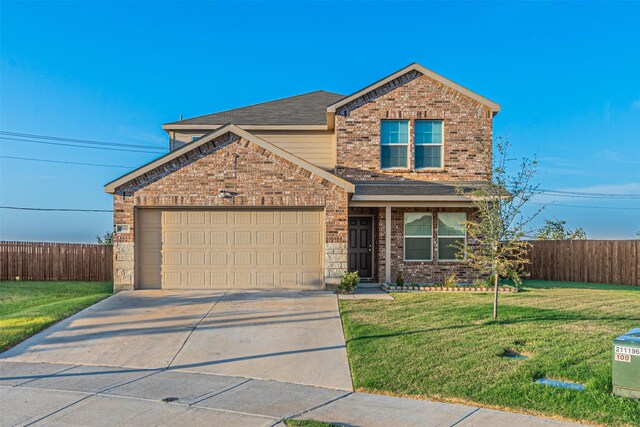 view of front property featuring a front lawn and a garage