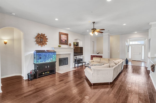 living room with ceiling fan and dark hardwood / wood-style flooring