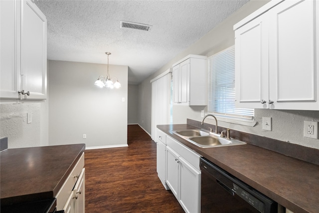 kitchen featuring a textured ceiling, dishwasher, dark wood-type flooring, sink, and a chandelier