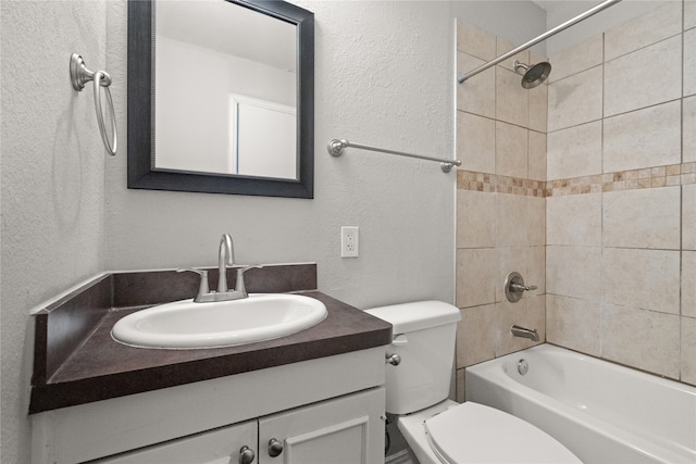 full bathroom featuring vanity, toilet, and tiled shower / bath