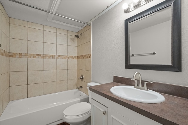 full bathroom with tiled shower / bath, vanity, and toilet