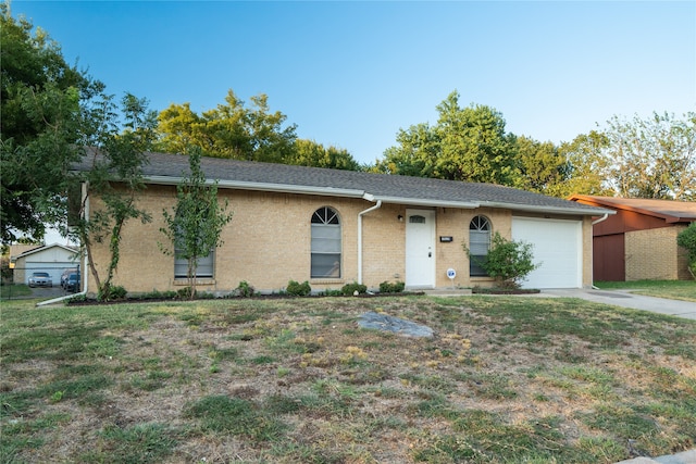 ranch-style house with a front yard and a garage