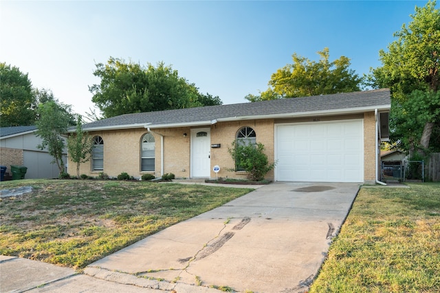 single story home featuring a garage and a front yard