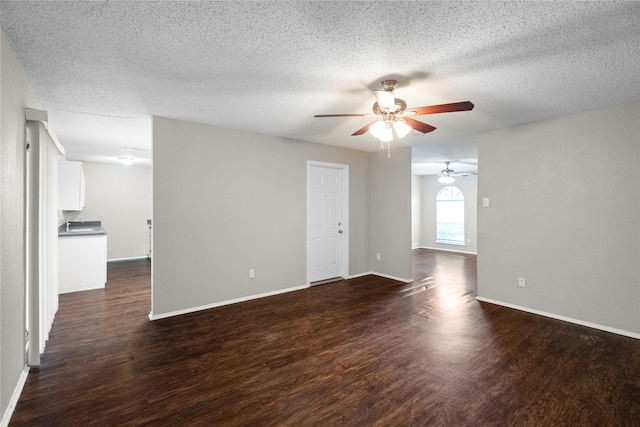 unfurnished room with dark hardwood / wood-style flooring, ceiling fan, and a textured ceiling