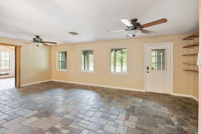 interior space with ceiling fan