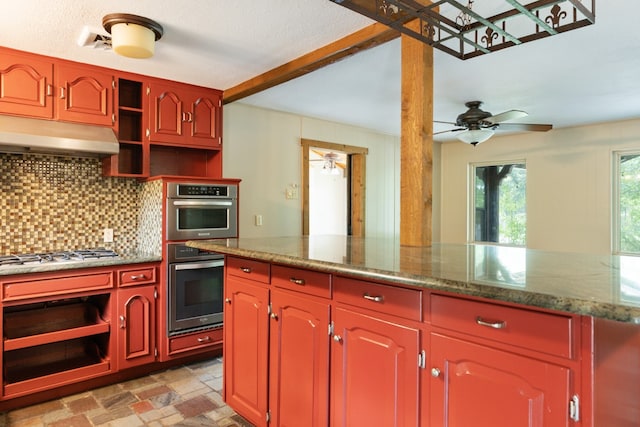 kitchen featuring tasteful backsplash, stone counters, ceiling fan, and appliances with stainless steel finishes