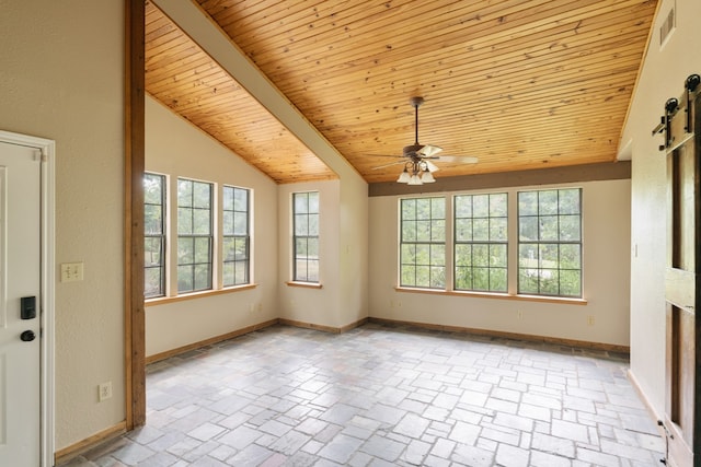 empty room with a barn door, ceiling fan, wooden ceiling, and vaulted ceiling