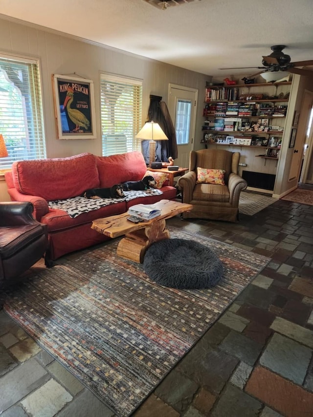 living room with a wealth of natural light and ceiling fan