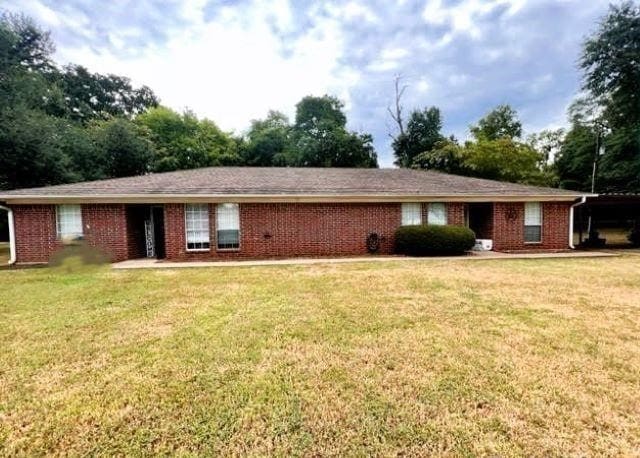 ranch-style house with a front lawn