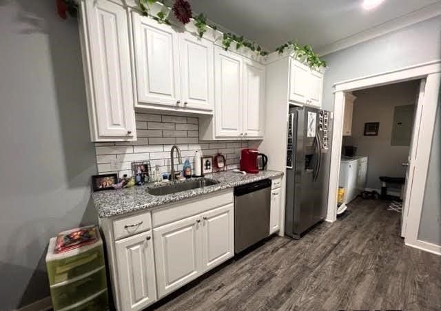 kitchen with stainless steel appliances, sink, dark hardwood / wood-style flooring, and white cabinets