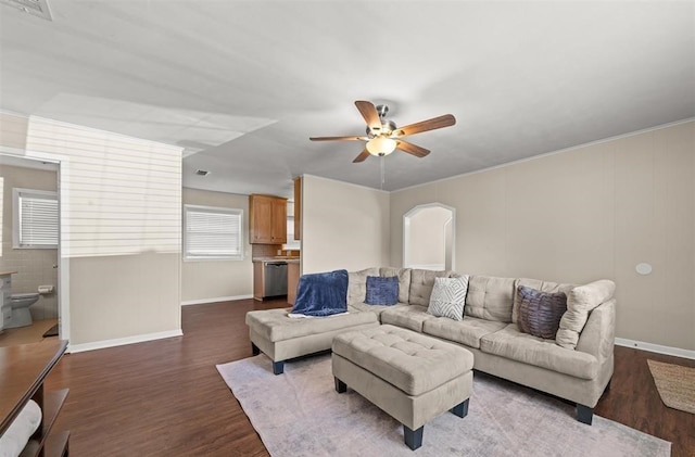 living room with ceiling fan and dark hardwood / wood-style flooring