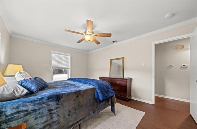 bedroom with crown molding, dark wood-type flooring, and ceiling fan