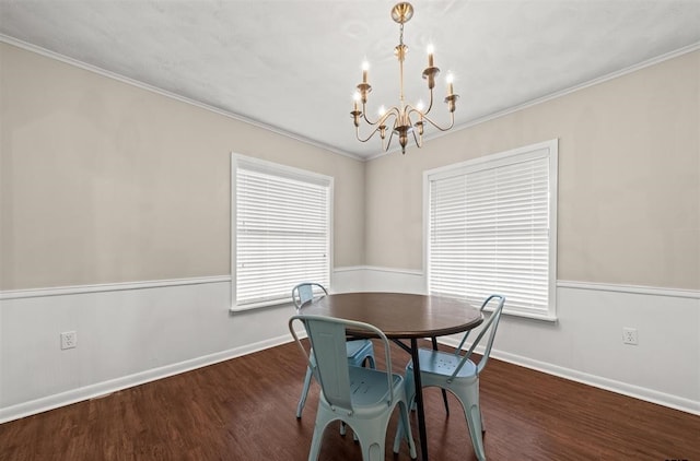 dining space featuring ornamental molding, dark hardwood / wood-style floors, and a notable chandelier