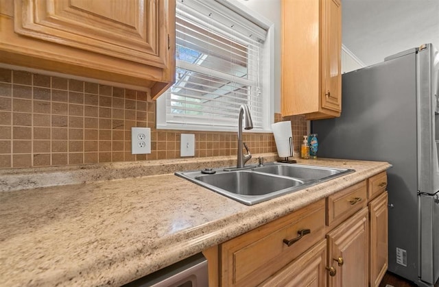 kitchen featuring sink and tasteful backsplash