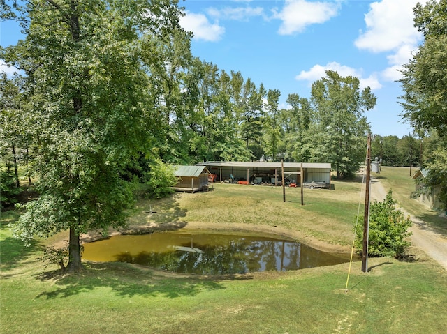 view of community with a water view and a yard