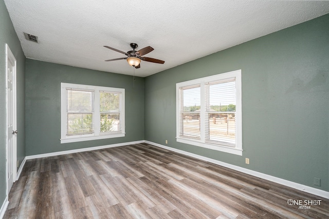 spare room featuring a textured ceiling, ceiling fan, and hardwood / wood-style floors