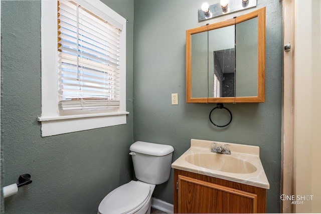 bathroom featuring toilet and vanity