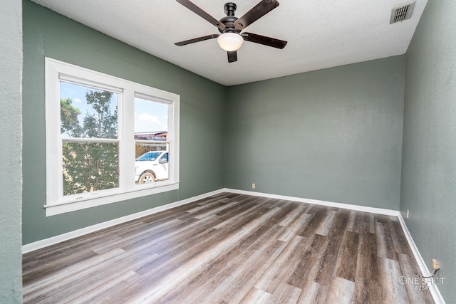 empty room featuring wood-type flooring, a textured ceiling, and ceiling fan