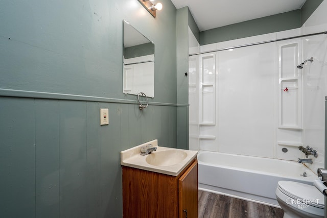 full bathroom with vanity, toilet, washtub / shower combination, and hardwood / wood-style flooring