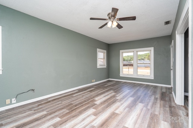 interior space featuring a textured ceiling, ceiling fan, and hardwood / wood-style flooring