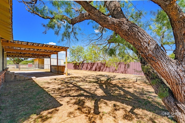 view of yard with a pergola and a patio