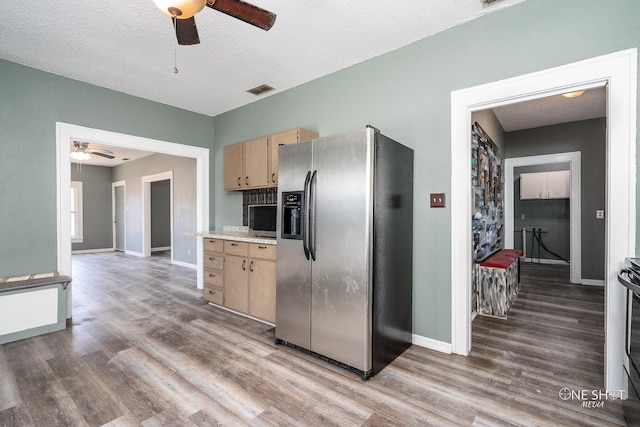 kitchen with a textured ceiling, dark wood-type flooring, ceiling fan, and stainless steel refrigerator with ice dispenser