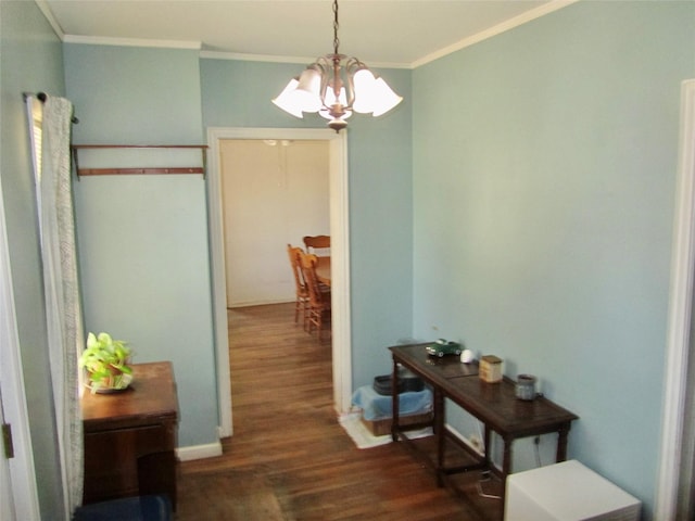 hall featuring a notable chandelier, ornamental molding, and wood finished floors