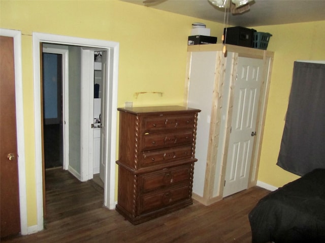 bedroom featuring wood finished floors and baseboards