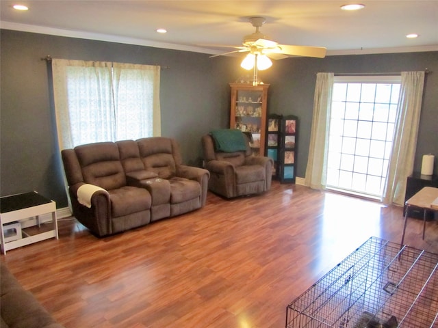 living room with a wealth of natural light, ceiling fan, and hardwood / wood-style floors