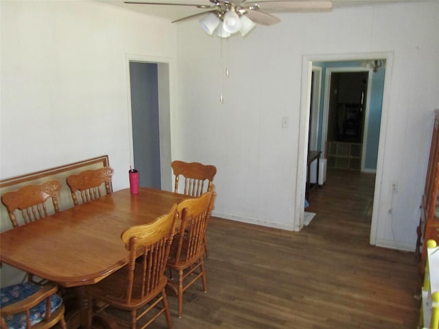 dining space with a ceiling fan and wood finished floors