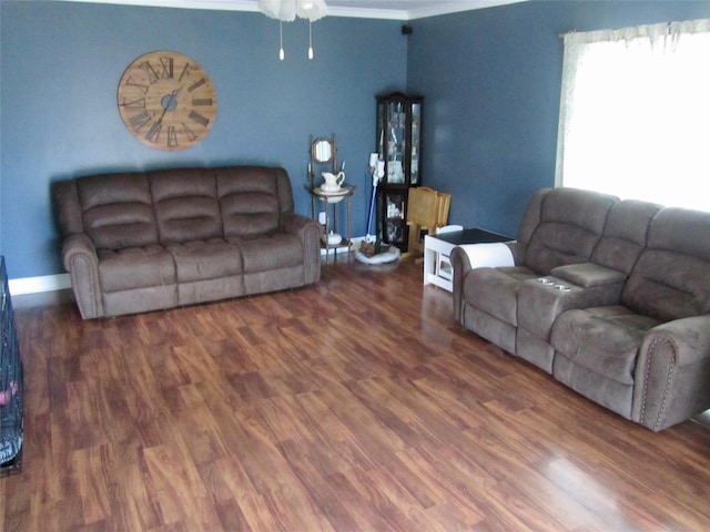 living area featuring ornamental molding, baseboards, ceiling fan, and wood finished floors