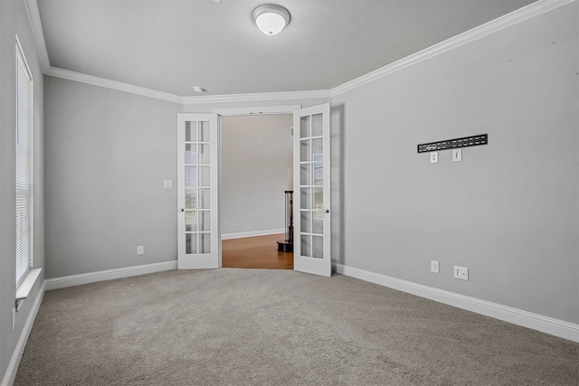 unfurnished room with ornamental molding, french doors, and carpet