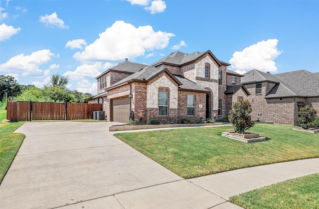 view of front of property featuring a front yard and central AC