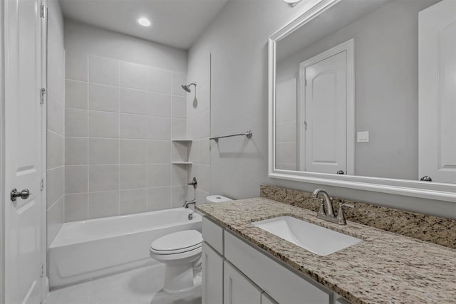 full bathroom with tiled shower / bath, vanity, toilet, and tile patterned flooring