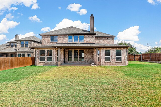 back of house with a yard and a patio area