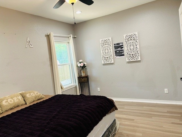 bedroom featuring ceiling fan and hardwood / wood-style flooring