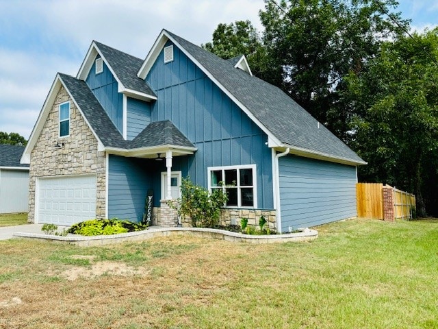 craftsman inspired home featuring a garage and a front lawn