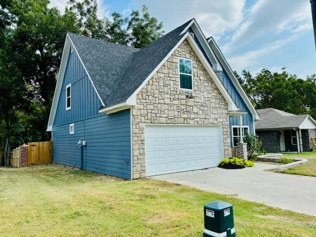 view of side of home with a garage and a yard