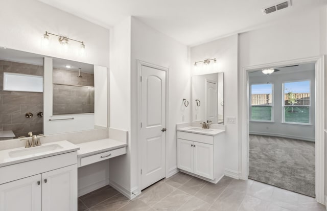 bathroom with vanity and tiled shower