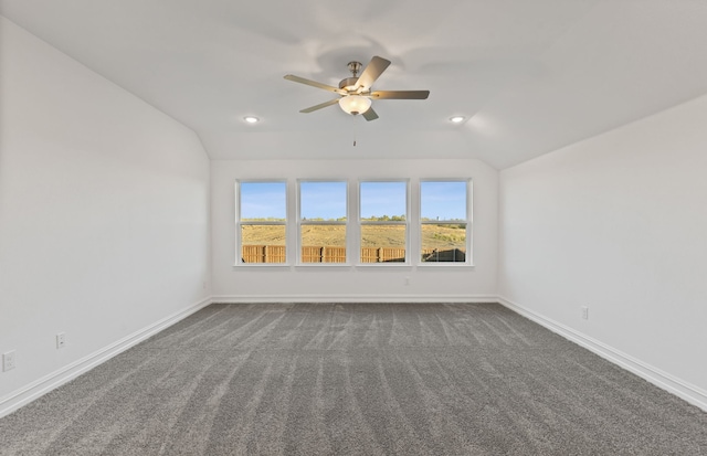 spare room with carpet floors, vaulted ceiling, and ceiling fan