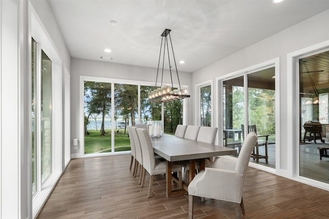 dining space featuring hardwood / wood-style flooring and a chandelier