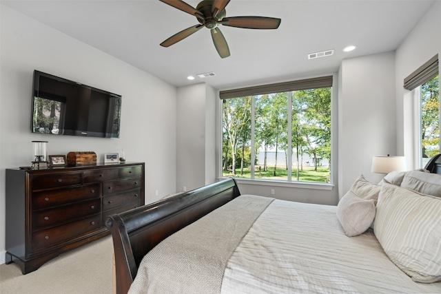 bedroom with ceiling fan and light colored carpet